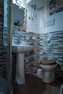 a bathroom with a toilet and a sink at Castro's Appartament in Palermo