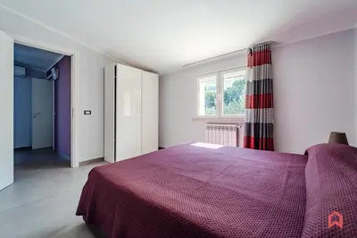 a bedroom with a purple bed and a window at Villa Privata con Piscina a Scopello in Castellammare del Golfo