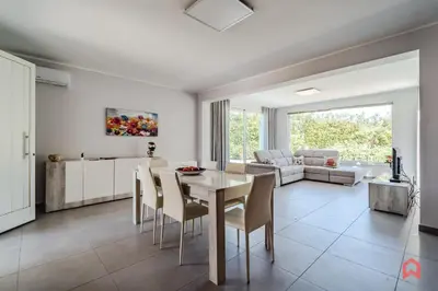 a kitchen and living room with a table and chairs at Villa Privata con Piscina a Scopello in Castellammare del Golfo