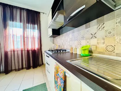 a kitchen with a stove and a counter top at O Firrìu in Carini