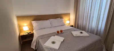 a hotel room with a bed with two towels on it at Ruby Home in Palermo