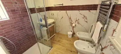 a bathroom with two toilets and a glass shower at Ruby Home in Palermo