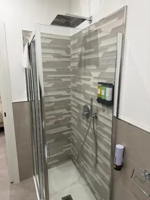 a shower with a glass door in a bathroom at Casa Leo in Palermo