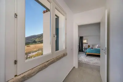 a room with a window and a bedroom with a bed at Villa Coraline - Castellammare in Balata di Baida