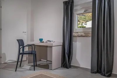 a desk and chair in a room with a window at Villa Coraline - Castellammare in Balata di Baida