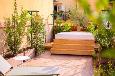 a garden with plants and stairs with a table at Solemar Sicilia - Goethehaus in Palermo