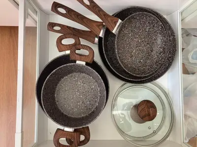 three pots and pans and a mirror in a drawer at Sunny studio with terrace in best central area in Palermo