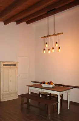 a dining room with a table and a bench at Agriturismo Masseria Castellana in Monreale