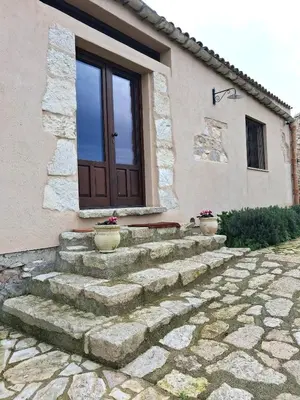 a set of stairs leading to a house with a door at Agriturismo Masseria Castellana in Monreale