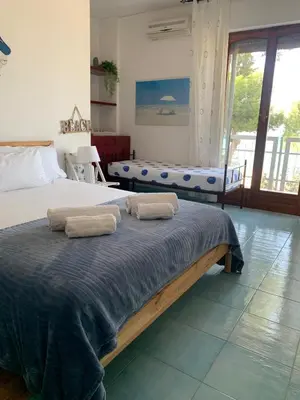 a bedroom with two beds with towels on them at Rocca Appartament Palermo Beach in Palermo