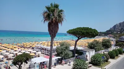 a view of a beach with umbrellas and the ocean at Rocca Appartament Palermo Beach in Palermo