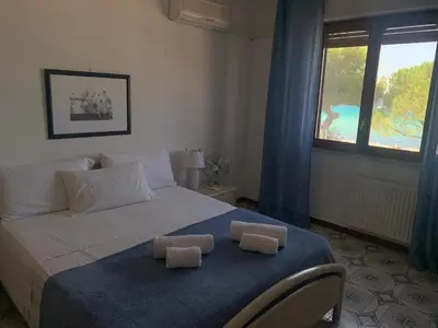 a bedroom with a bed with two towels on it at Rocca Appartament Palermo Beach in Palermo