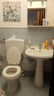 a bathroom with a toilet and a sink at Rocca Appartament Palermo Beach in Palermo