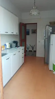 a kitchen with white cabinets and a refrigerator at Rocca Appartament Palermo Beach in Palermo