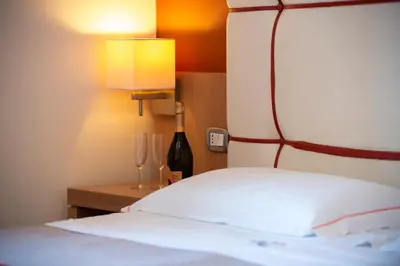 a bedroom with a red couch and a desk at Al ritrovo in Castelluzzo
