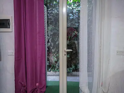 a window with purple curtains in a room at Casaulente Mare in Alcamo Marina