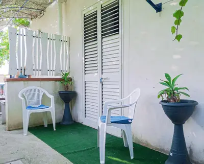 a patio with two chairs and a table at Casaulente Mare in Alcamo Marina