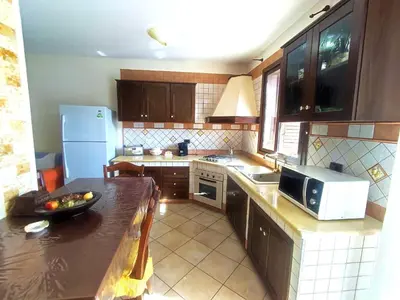 a kitchen with wooden cabinets and a counter top at Casa La Plaza in Balestrate