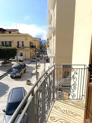 a balcony with a car parked in a parking lot at Casa La Plaza in Balestrate