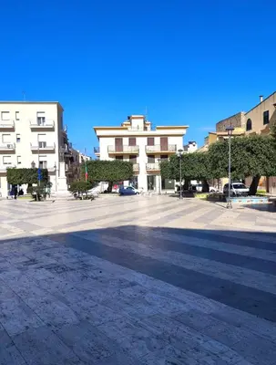 an empty street in a city with buildings at Casa La Plaza in Balestrate