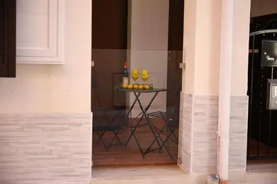 a table with yellow vases on it in a room at L'arco Sul Mare in Balestrate