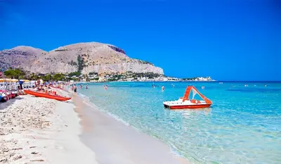 a beach with a bunch of boats in the water at Central Post Office Guest House in Palermo