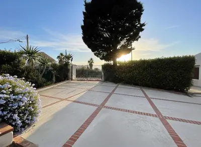a walkway with flowers and a tree in a yard at Casa Manzella Apartments in Cinisi