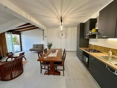 a kitchen and dining room with a table and chairs at Casa Manzella Apartments in Cinisi