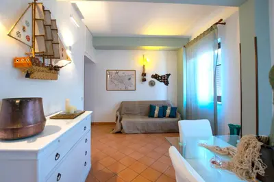 a living room with a table and a couch at Mare Holidays in Palermo