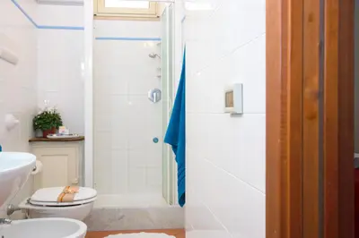 a bathroom with a toilet and a shower at Mare Holidays in Palermo
