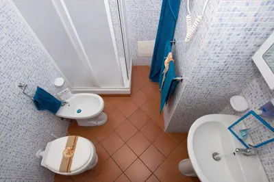 a small bathroom with a toilet and a sink at Mare Holidays in Palermo