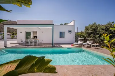 a villa with a swimming pool in front of a house at Rosvì Villa in Castellammare del Golfo