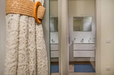 a bathroom with a shower curtain and a sink at Rosvì Villa in Castellammare del Golfo