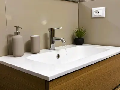 a bathroom sink with two soap dispensers on a counter at Casa NiMia al centro storico di Palermo in Palermo