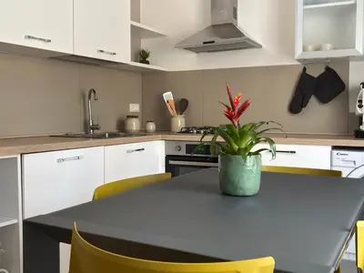 a kitchen with a table with a potted plant on it at Casa NiMia al centro storico di Palermo in Palermo