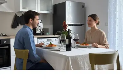 a man and woman sitting at a table with plates of food at Casa NiMia al centro storico di Palermo in Palermo
