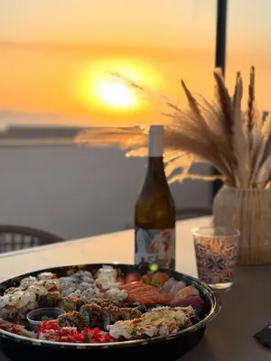a pan of food and a bottle of wine on a table at Casa Lo Bianco in Terrasini