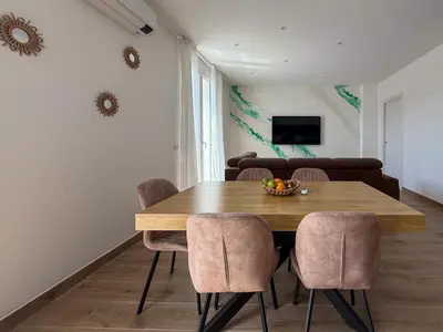 a dining room with a wooden table and chairs at Casa Lo Bianco in Terrasini