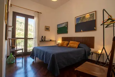 a bedroom with a bed and a large window at GaR07 in Castellammare del Golfo