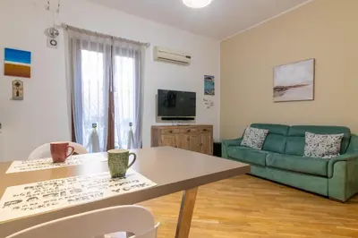 a living room with a couch and a table at GuestHost - Al Cassaro Holiday Home in Palermo