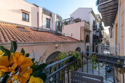 a balcony with a bench and some buildings at GuestHost - Al Cassaro Holiday Home in Palermo