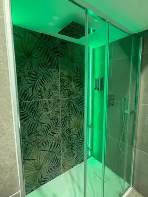 a shower with a glass door with a green ceiling at Luxury Rooms Soraja in Palermo