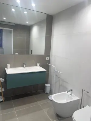 a bathroom with a sink and a toilet and a mirror at Luxury Rooms Soraja in Palermo