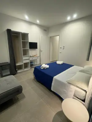 a large bedroom with a large bed and a couch at Luxury Rooms Soraja in Palermo