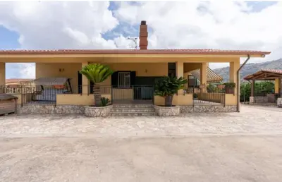 a house with a porch with plants on it at Villa Oasi della Pace based in Partinico in Partinico