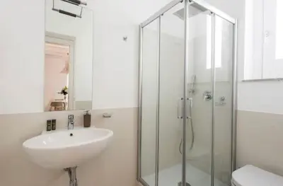 a bathroom with a sink and a glass shower at Mori apartment Libertà Politeama in Palermo