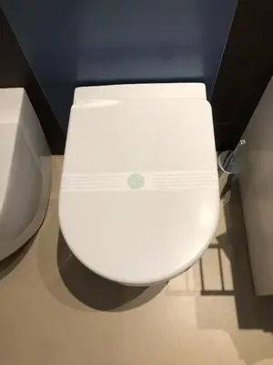 a white toilet in a bathroom with its lid down at Mori apartment Libertà Politeama in Palermo