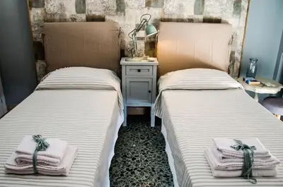 two beds sitting next to each other in a room at Guelio al Massimo Suites&Breakfast in Palermo