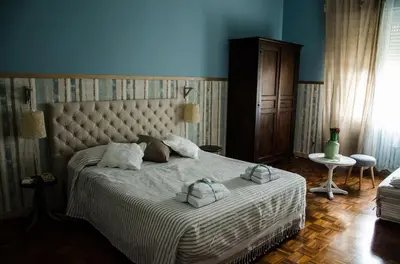 a bedroom with a large bed with two towels on it at Guelio al Massimo Suites&Breakfast in Palermo