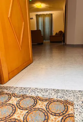 a room with a door and a rug on the floor at Attico Giusy in Balestrate